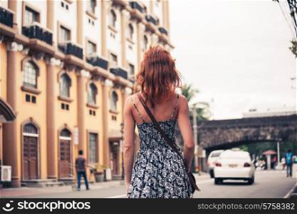 A young caucasian woman is walking in Manila