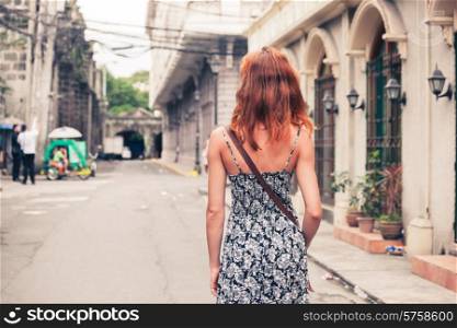 A young caucasian woman is walking in Manila