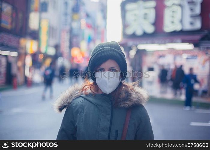 A young caucasian woman is wearing a face mask in Japan