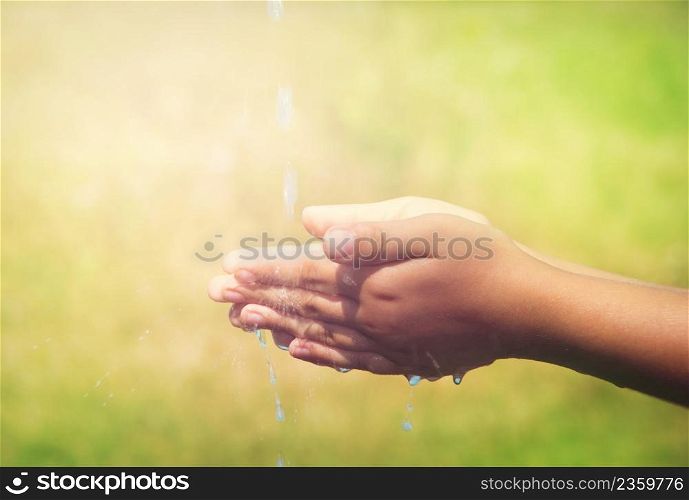 A young child is washing his hand.