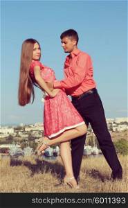 A young couple dancing in the outdoor