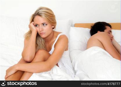 a young couple in bed having problems and crisis. divorce and separation.
