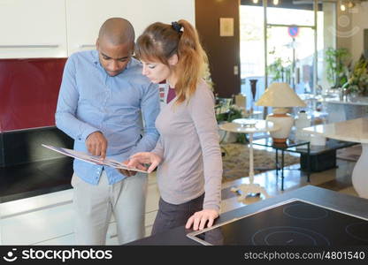 a young couple reading a legal document in a house