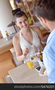 A young couple sitting at a table and have lunch at an outdoor restaurant