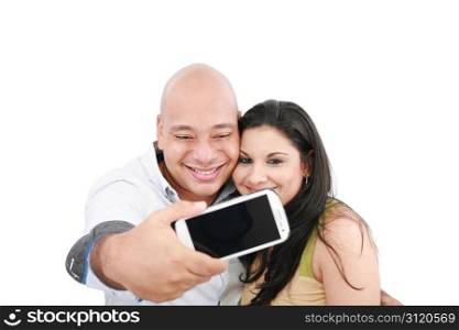 A young couple taking their picture on a mobile phone (focus on mobile phone screen)