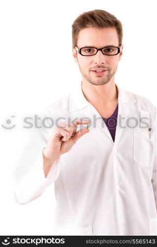 A young doctor holding some pills, isolated over white