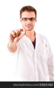 A young doctor holding some pills, isolated over white