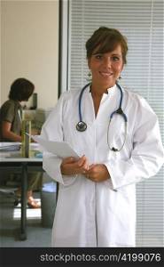 a young doctor with a stethoscope. in her medical practice