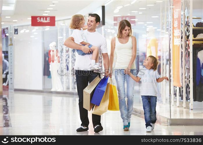 A young family of four with children in the store