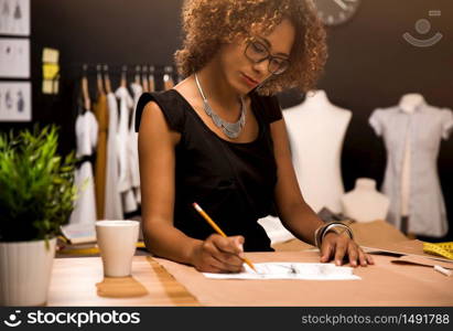 A young fashion designer working on her atelier