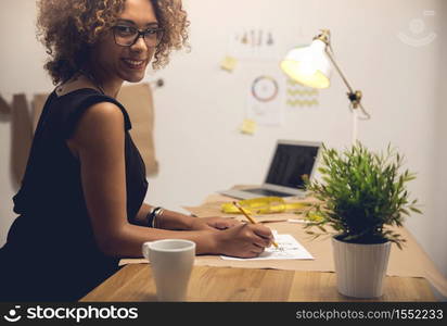 A young fashion designer working on her atelier