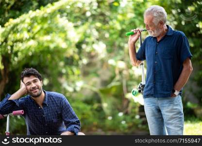 A young father and son are having fun with a childhood toy.