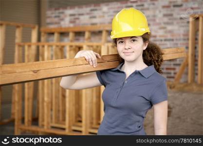 A young female apprentice working on a construction site.