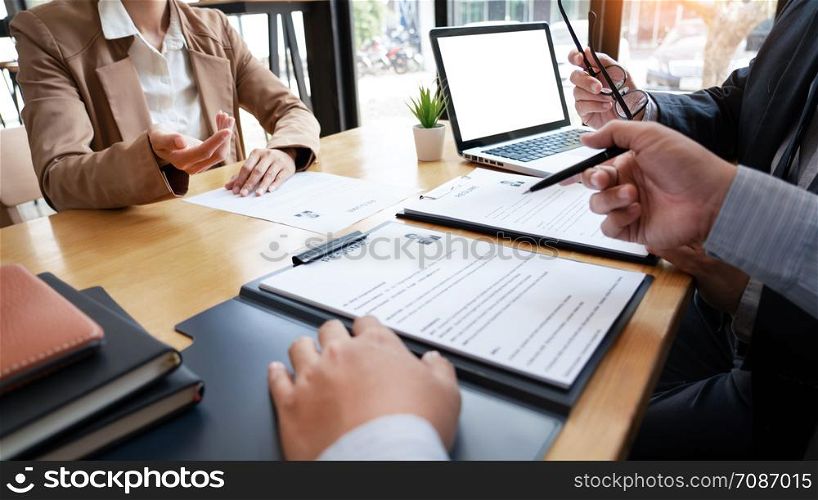 A Young Female Business women Applicant In Office Male Manager Interviewing holding resume and speaking to employer, job Interview employment and recruitment concept