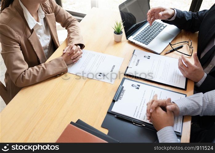 A Young Female Business women Applicant In Office Male Manager Interviewing holding resume and speaking to employer, job Interview employment and recruitment concept