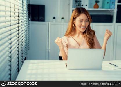 A young female employee receives a promotion, good news or finished her task and overjoyed for being a competent worker.. A young female employee receives a promotion for being a competent worker.