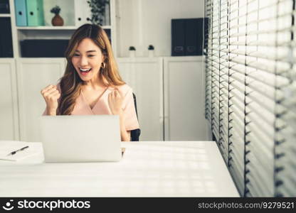 A young female employee receives a promotion, good news or finished her task and overjoyed for being a competent worker.. A young female employee receives a promotion for being a competent worker.