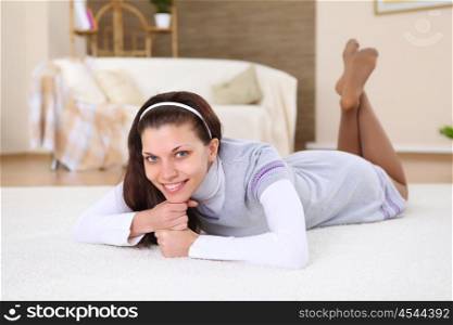 a young female student at home on the floor in the living room