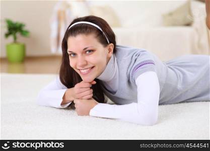 a young female student at home on the floor in the living room