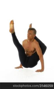 A young fit man practices Yoga.