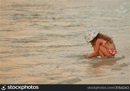 A young girl (6-8) playing in the sea, Moorea, Tahiti, French Polynesia, South Pacific