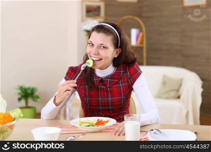 a young girl eating healthy food at home