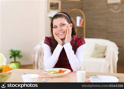 a young girl eating healthy food at home