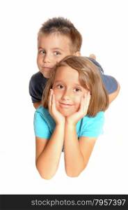 A young girl, holding her face in her hands and her brother is lying onher back, isolated for white background.