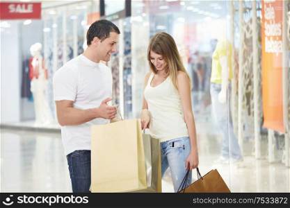 A young girl looks into the shopping bag with men