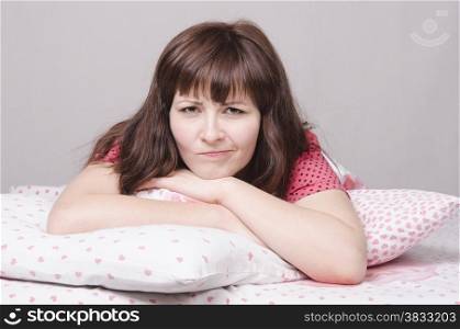 A young girl lying in bed pillow