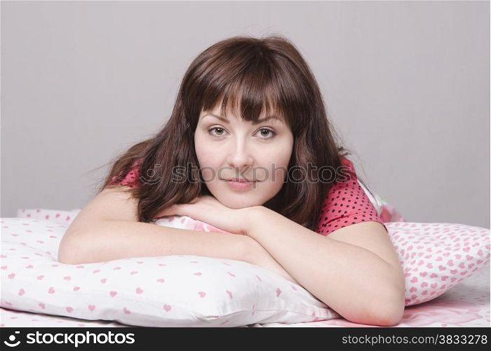 A young girl lying in bed pillow
