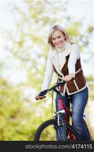 A young girl on a bicycle in the park