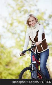 A young girl on a bicycle in the park