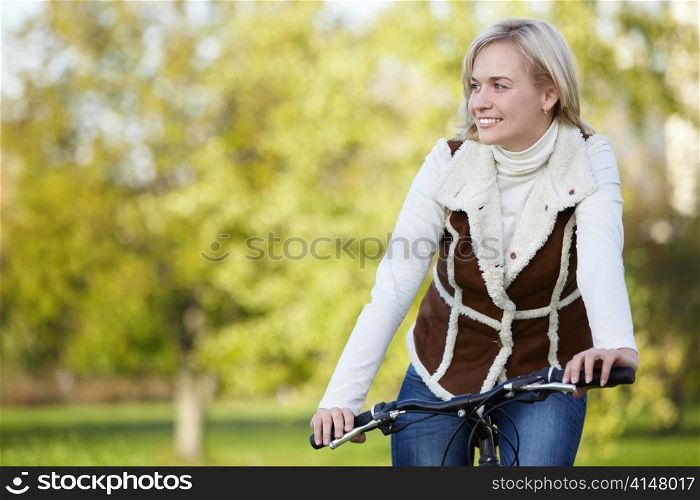 A young girl rides a bicycle outdoors