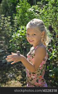 A young girl with a snail