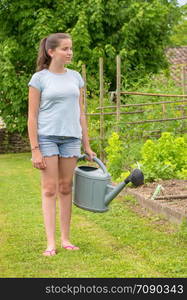 a young girl with a watering can in the garden