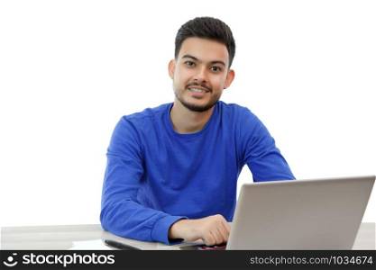 a young guy sitting at a laptop in search of work,doing business on the Internet. on light background