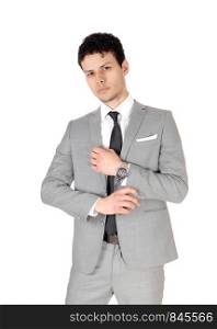 A young handsome business man standing in the studio in a light gray suit, thinking, looking into the camera, isolated for white background