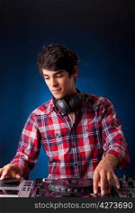A young handsome deejay boy playing some music