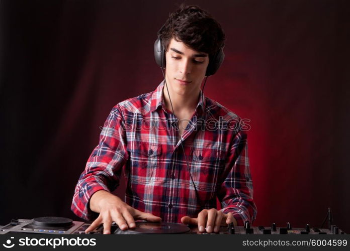 A young handsome deejay boy playing some music