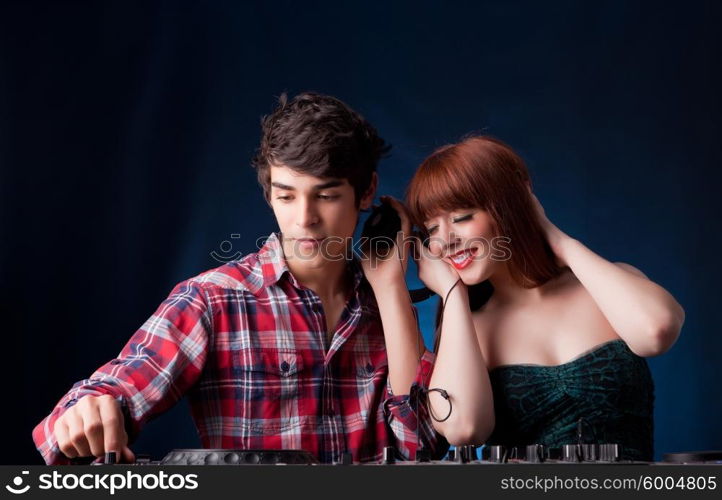 A young handsome deejay boy playing some music