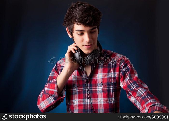 A young handsome deejay boy playing some music