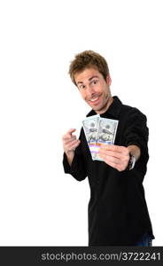 A young handsome man holding a lot of new hundred dollar bills isolated on white background. This newly redesigned US currency was released for circulation in October of 2013.