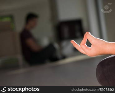 A young handsome woman doing yoga exercises on the floor of her luxury home villa