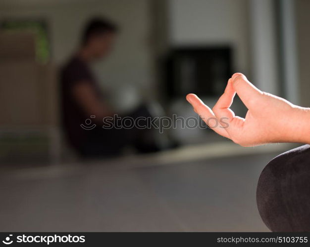 A young handsome woman doing yoga exercises on the floor of her luxury home villa