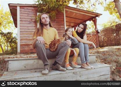 A young happy family sitting in the porch