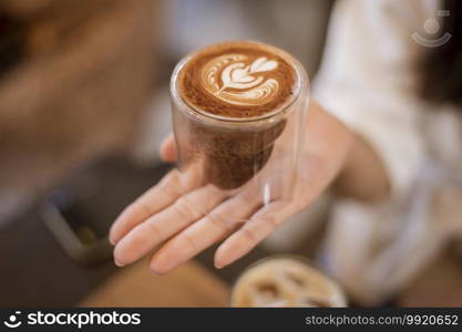 A young happy woman enjoying and relaxing in coffee shop