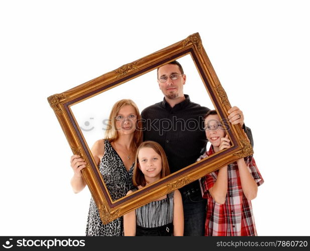 A young lovely family standing for white background and holding apicture frame in front of them.