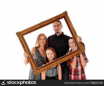 A young lovely family standing for white background and holding apicture frame in front of them.