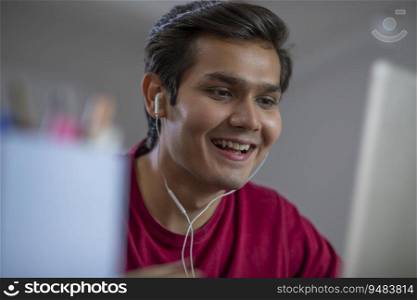 A YOUNG MAN ACTIVELY PARTICIPATING IN ONLINE CLASS